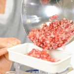 Putting the pomegranate seeds through a strainer